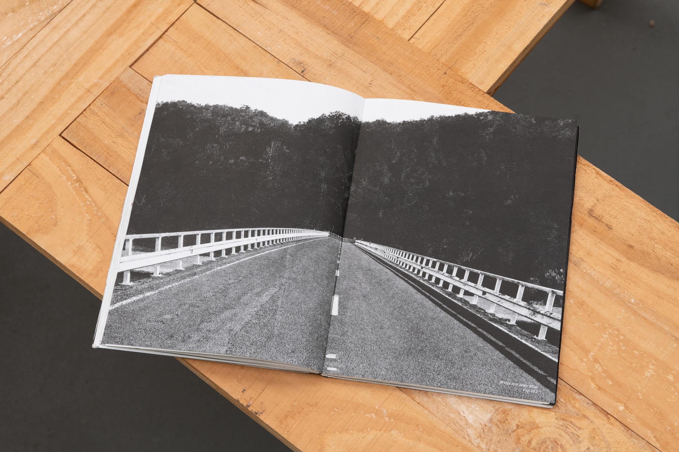 Inside spread of Finding Kuku featuring the bridge over the Motu River