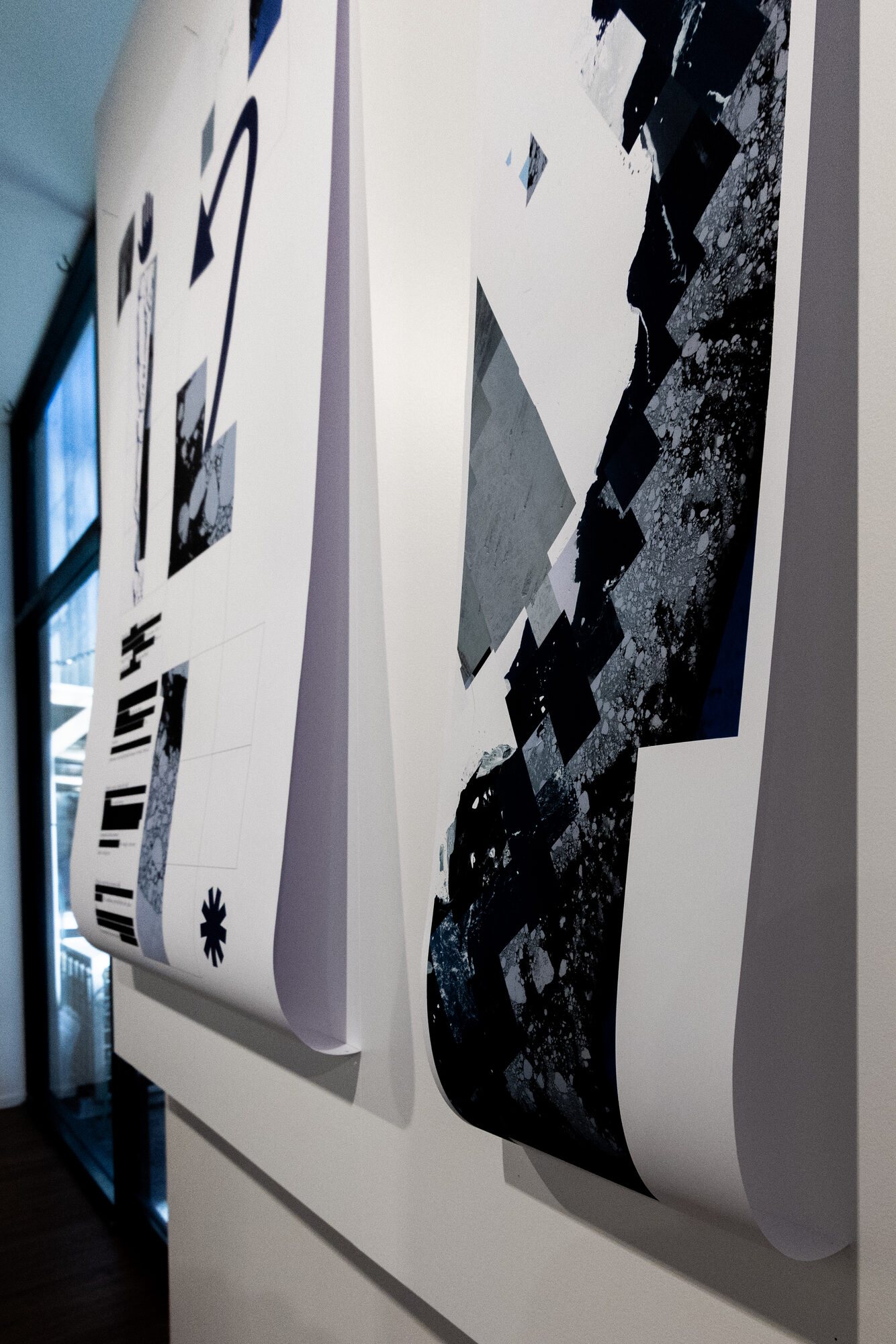Detail — two sheets curling away from the wall at the lower edge