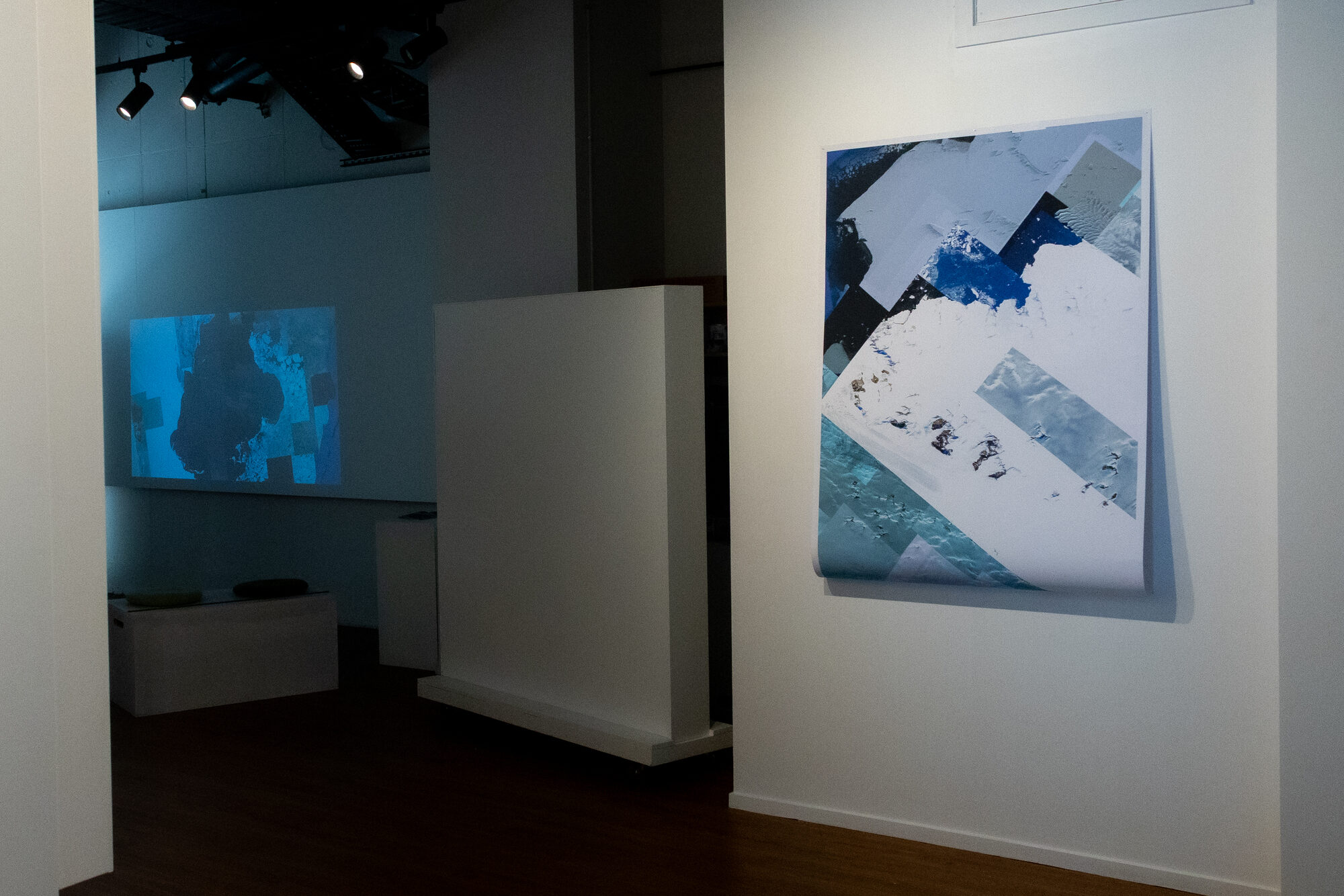 The same corner, the projection carrying into the next room
